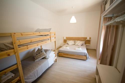 a room with two bunk beds in a room at La Balestra B&B in Balestrate