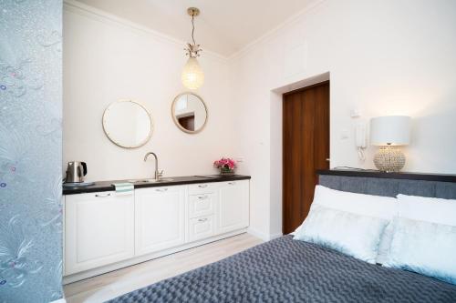 Ένα ή περισσότερα κρεβάτια σε δωμάτιο στο Apartamenty Magia