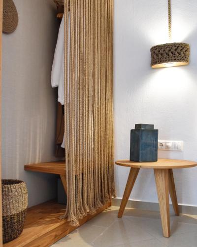 a room with a table and a curtain at Angelos Design Suites in Patitiri