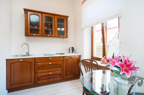 a kitchen with a glass table and a sink at Apartamenty Magia in Lublin