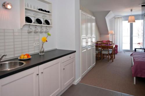a kitchen with white cabinets and a counter top at Nowe Guty Fun in Nowe Guty