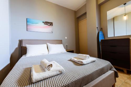 a bedroom with a bed with towels on it at Martimi Apartments - 200M from Drapanias Beach - Pool - Hot Tub - Sauna - BBQ in Kissamos
