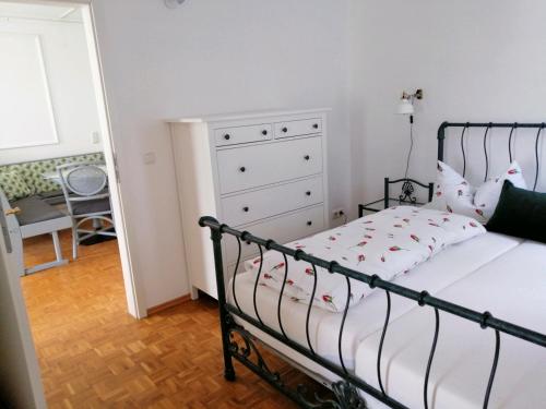 a bedroom with a bed and a dresser at Apartment Froschkönig in Gladenbach