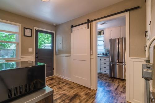 a kitchen with a refrigerator and a counter top at Italian Style in Old Town with Private Hot Tub in Fort Collins