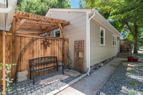 a small house with a fence and a bench at Italian Style in Old Town with Private Hot Tub in Fort Collins