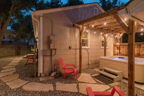 a pergola with two red chairs and a hot tub at Italian Style in Old Town with Private Hot Tub in Fort Collins