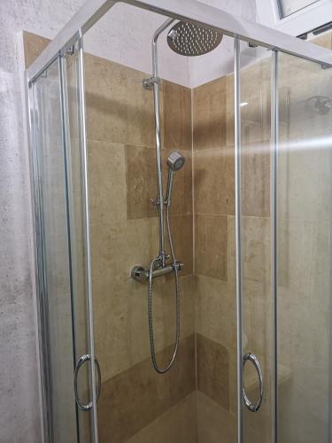 a shower with a glass door in a bathroom at B & B San Giovanni 9 in Gallipoli