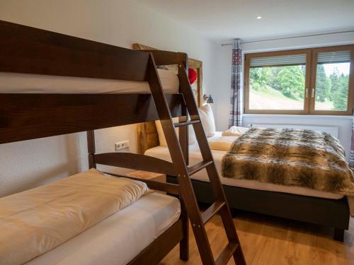 a bedroom with two bunk beds and a bed at Black Forest Apartements by Hotel Grüner Baum Feldberg in Feldberg