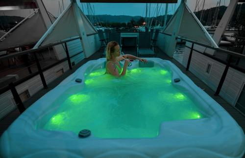 a girl in a hot tub on a boat at Floating Sea House Principessa in Portorož