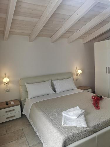 a bedroom with a large bed with two towels on it at B & B San Giovanni 9 in Gallipoli