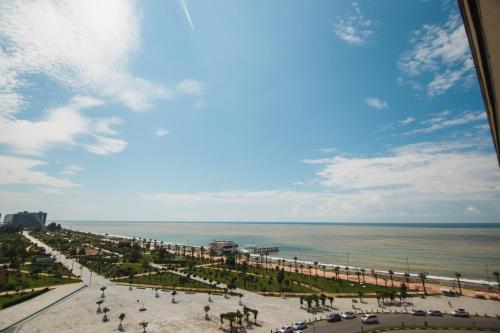 a view of the beach and the ocean from a building at Real Beach Tower in Batumi