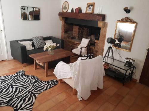a living room with a couch and a table at maison de charme en Luberon in Grambois