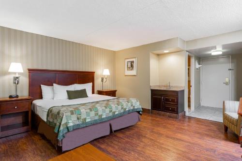 a hotel room with a bed and a bathroom at Days Inn by Wyndham Westminster in Westminster