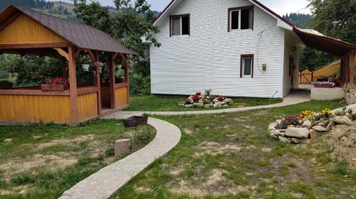 a house with a gazebo next to a yard at Садиба "Ековид" in Krivorovnya