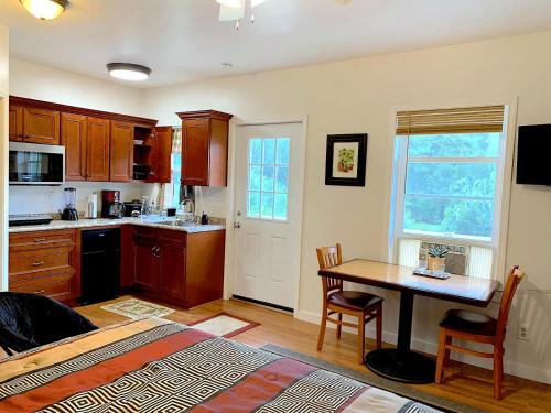 a kitchen with a table and a dining room at Micosta Leisure Inn in Hudson