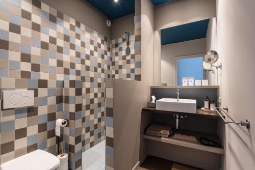 a bathroom with a sink and a mirror at Zakske13 - Design Boutique B&B in Bruges city centre in Bruges