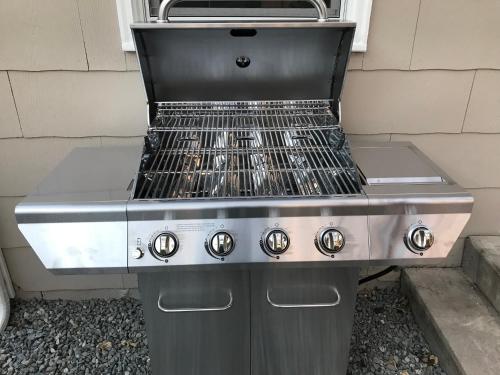 a gas grill sitting next to a building at Italian Style in Old Town with Private Hot Tub in Fort Collins