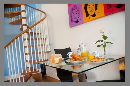 a glass table with food on it next to a staircase at Court Farm Barns in Warborough