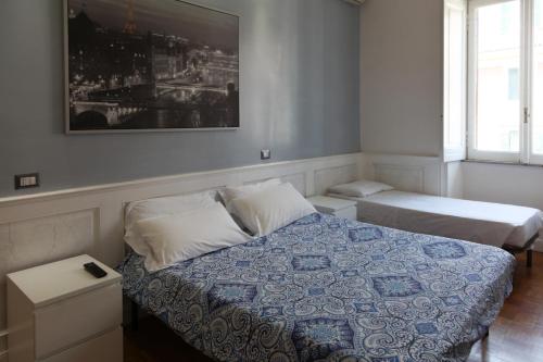 a bedroom with a bed and a picture on the wall at Vatican Room and Kitchen in Rome