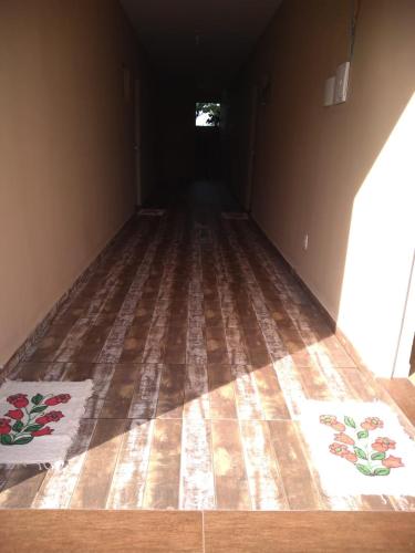 a dark room with two rugs on the floor at Residencial da Cris in Florianópolis