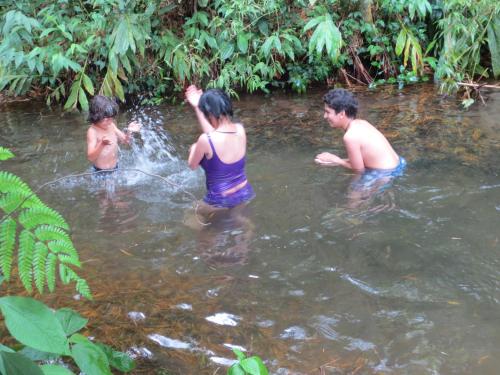 a group of people in a pool of water at La Posada del Cucú in Salento