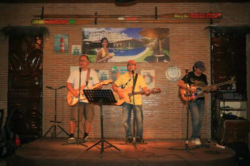 a group of people on a stage playing music at Wild Orchid Beach Resort in Olongapo