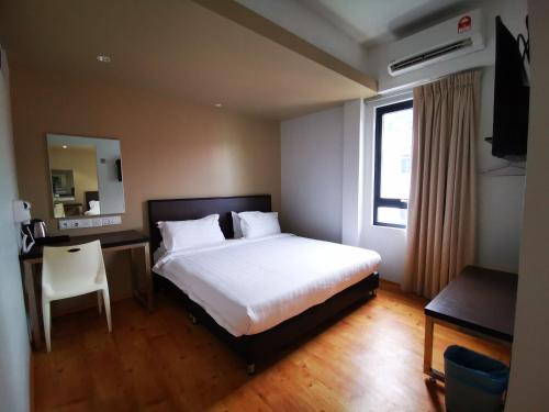 Postel nebo postele na pokoji v ubytování D'Green Hotel Kuching