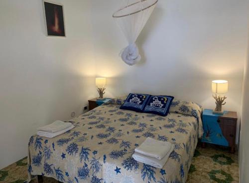 a bedroom with a bed with towels on it at Casa Mare Blu in Ginostra