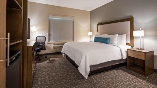 a hotel room with a large bed and a desk at Best Western Plus Hudson I-94 in Hudson
