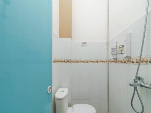 a bathroom with a toilet and a shower at RedDoorz at Tara Homestay Palembang in Palembang
