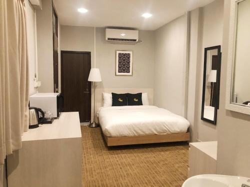 a bedroom with a bed with a black cat on it at GN Luxury Hostel in Bangkok