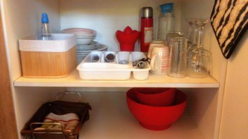 a cupboard with dishes and other kitchen items on it at Cabañas Te Maori in Hanga Roa