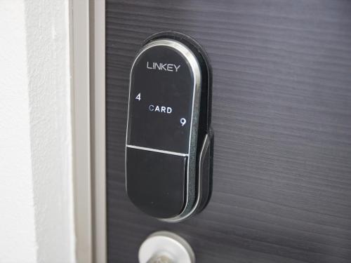 a black door handle with a cell phone on it at Hotel Cuore Kokusai Dori Naha in Naha