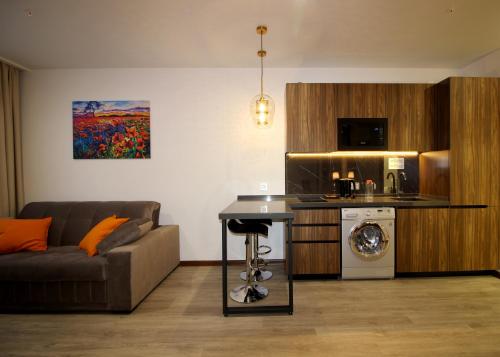 a living room with a couch and a kitchen at Hotel Avanta in Vladivostok