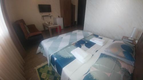 a bedroom with a bed with a blue and white blanket at Villa Royal House in Makhinjauri