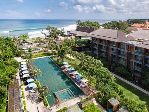 an aerial view of a resort with a pool at Hotel Indigo Bali Seminyak Beach by IHG in Seminyak