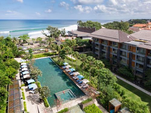 an aerial view of a resort with a pool at Hotel Indigo Bali Seminyak Beach, an IHG Hotel in Seminyak