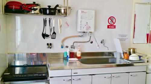 a kitchen with a sink and a stove at Benidaruma - Dango in Kyoto