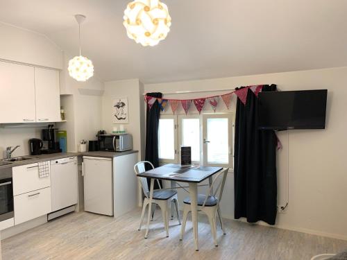 a kitchen with a table and chairs in a room at Green Door Apartments in Jyväskylä