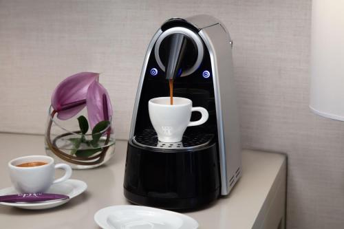 a coffee maker is making a cup of coffee at Mercure Hai Phong in Hai Phong