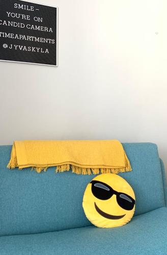 a pillow with a smiley face wearing sunglasses at The Harbour Apartments in Jyväskylä