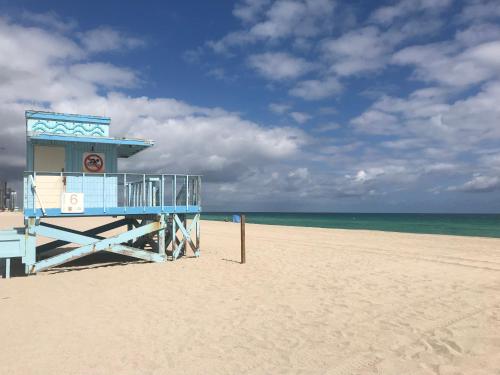 a blue life guard station on the beach at The King David Condos in Miami Beach