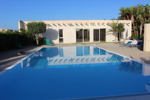 a swimming pool in front of a house at Villetta di Nonna Giovanna in Marsala