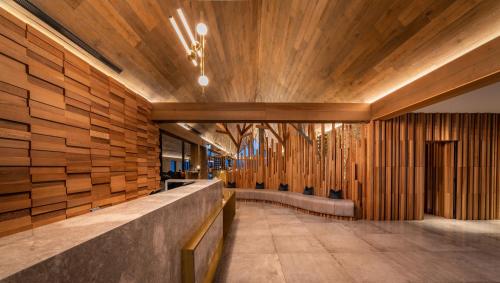 a lobby with wood paneling and a row of benches at Kamana Lakehouse in Queenstown