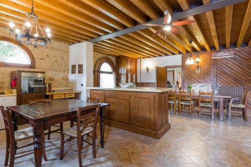 a large kitchen with wooden ceilings and tables and chairs at Medieval Relais - Top location in Montagnana