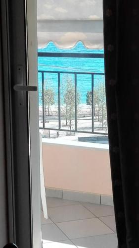 a view of the ocean from a room with a window at Brb rooms in Himare