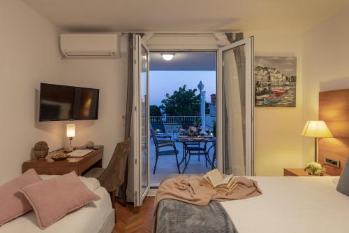 a bedroom with a bed and a view of a patio at Adriatic Apartment in Dubrovnik