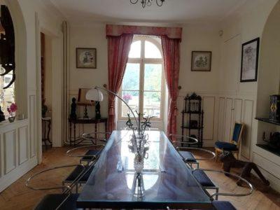 a living room with a table and a window at Château de la Bucaille - entier in Aincourt