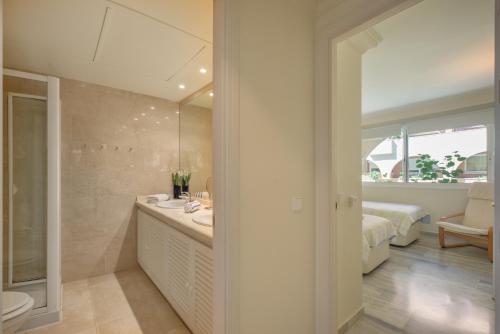 a bathroom with a sink and a mirror at Edificio Magna Marbella in Marbella