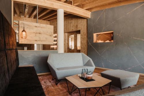 a living room with a blue couch and a table at Alpina Wagrain in Wagrain